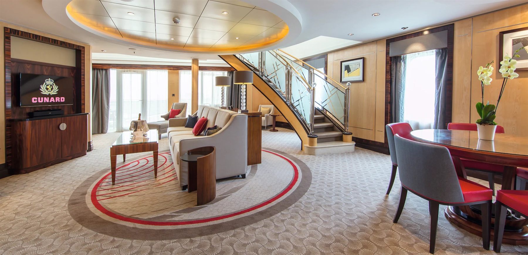The two-level Balmoral suite aboard Cunard’s Queen Mary 2 with a spiral staircase and dining table